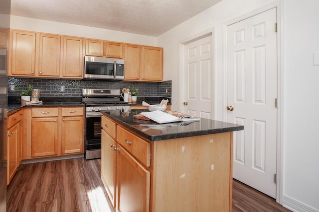 1808 Primrose Ave, Lewis Center, OH 43035 - kitchen featuring appliances with stainless steel finishes, dark wood-type flooring, tasteful backsplash, a kitchen island, and light brown cabinets