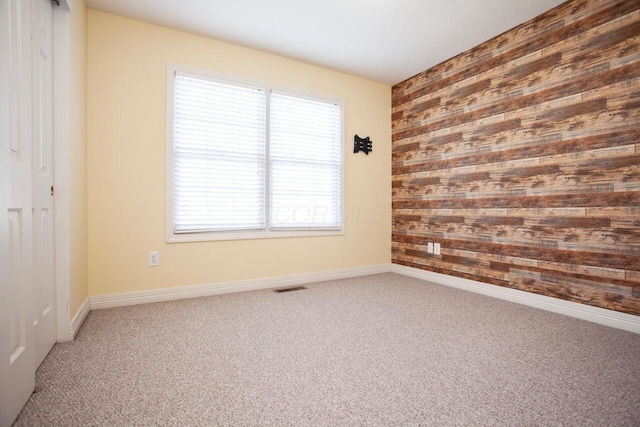 1808 Primrose Ave, Lewis Center, OH 43035 - carpeted spare room with wood walls, baseboards, and an accent wall