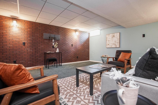 1808 Primrose Ave, Lewis Center, OH 43035 - carpeted living area featuring brick wall, baseboards, and a paneled ceiling