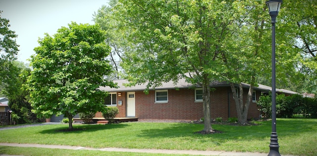 1134 Garden Rd, Columbus, OH 43224 - view of front facade featuring brick siding and a front lawn