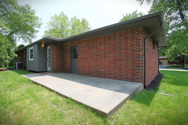 1134 Garden Rd, Columbus, OH 43224 - rear view of property with a patio area, a yard, and brick siding