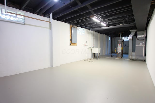 1134 Garden Rd, Columbus, OH 43224 - below grade area featuring water heater, electric panel, heating unit, and a sink