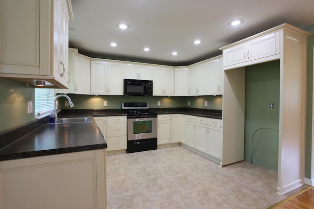 1134 Garden Rd, Columbus, OH 43224 - kitchen featuring stainless steel range, black microwave, a sink, recessed lighting, and dark countertops