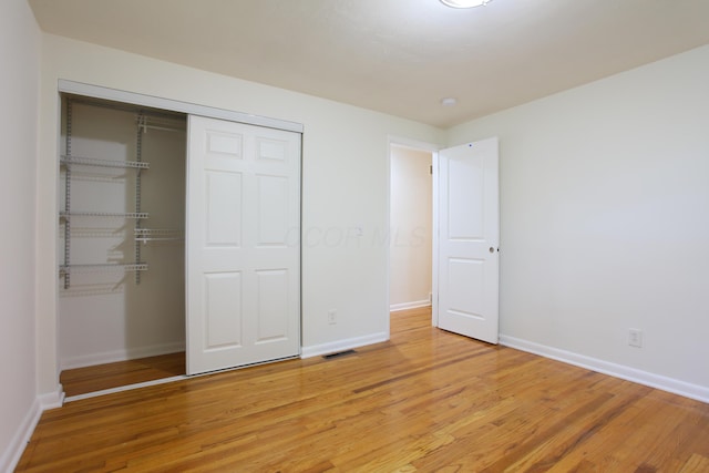 1134 Garden Rd, Columbus, OH 43224 - unfurnished bedroom with a closet, baseboards, and light wood finished floors