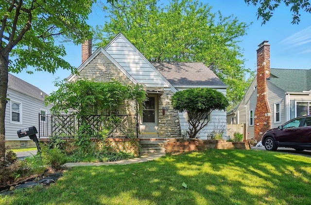443 Binns Blvd, Columbus, OH 43204 - view of front of property with a chimney, a front lawn, and stone siding