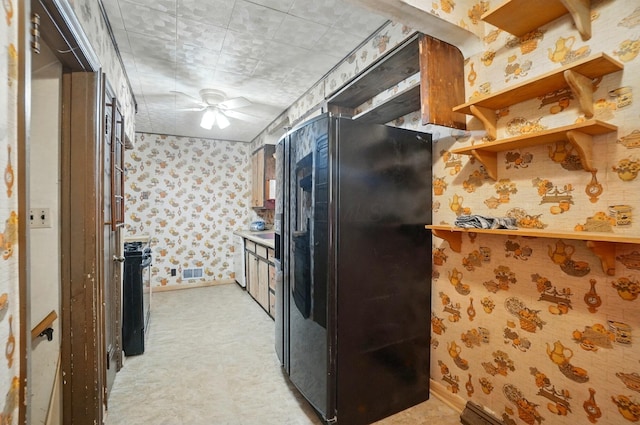 443 Binns Blvd, Columbus, OH 43204 - kitchen with freestanding refrigerator, wallpapered walls, range with gas cooktop, light flooring, and baseboards
