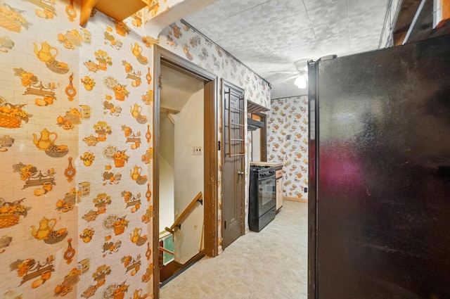 443 Binns Blvd, Columbus, OH 43204 - corridor featuring wallpapered walls, light carpet, baseboards, and an upstairs landing