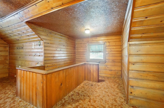 443 Binns Blvd, Columbus, OH 43204 - hallway with carpet, wood walls, and vaulted ceiling