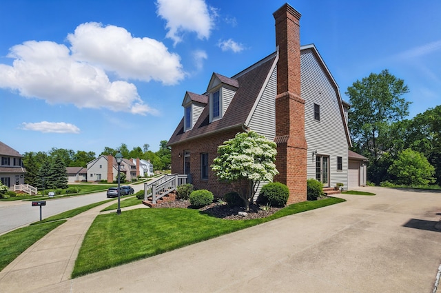 791 York St W, Mansfield, OH 44904 - view of home's exterior featuring a chimney, brick siding, a lawn, a residential view, and a garage