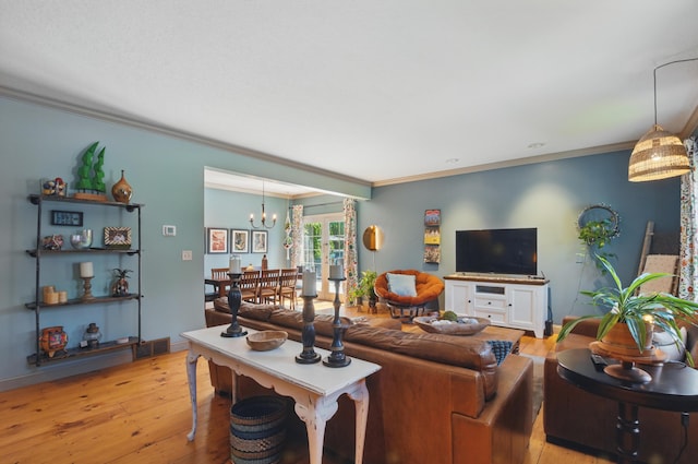 791 York St W, Mansfield, OH 44904 - living area with crown molding, light wood-type flooring, and a chandelier