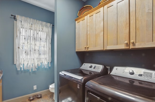 791 York St W, Mansfield, OH 44904 - laundry area featuring washing machine and dryer, baseboards, tile patterned floors, and cabinet space