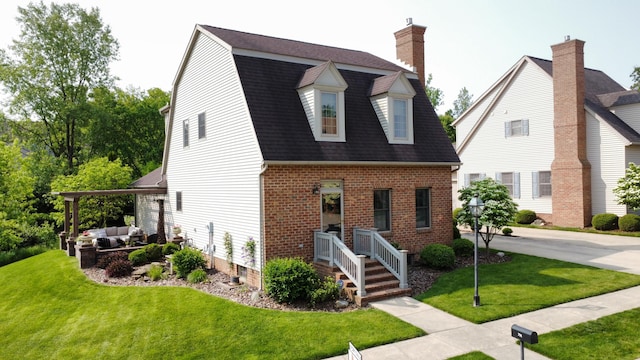 791 York St W, Mansfield, OH 44904 - dutch colonial with outdoor lounge area, a front lawn, brick siding, and a chimney