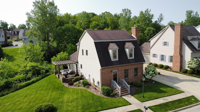 791 York St W, Mansfield, OH 44904 - view of front of home featuring brick siding, a front yard, a chimney, roof with shingles, and a gambrel roof