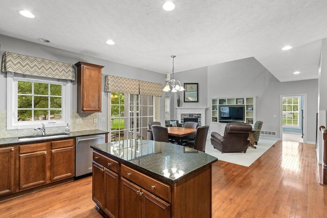 345 Quarter Way, Delaware, OH 43015 - kitchen with stainless steel dishwasher, a sink, open floor plan, light wood-style flooring, and tasteful backsplash