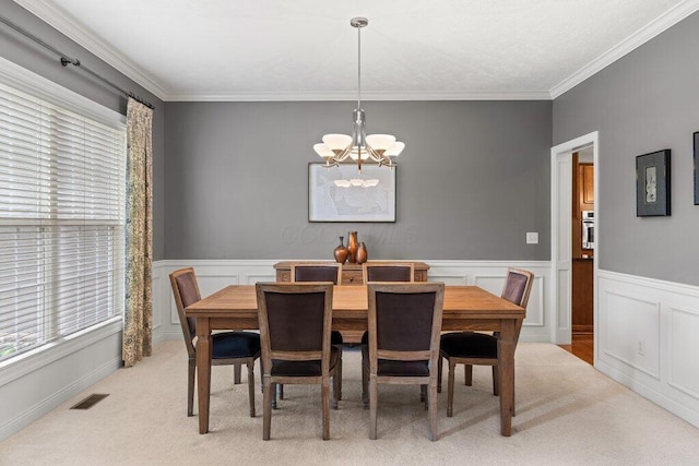 345 Quarter Way, Delaware, OH 43015 - dining space featuring a chandelier, light carpet, ornamental molding, and wainscoting