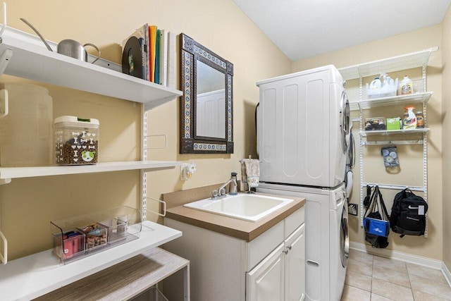 345 Quarter Way, Delaware, OH 43015 - washroom featuring stacked washer / dryer, light tile patterned flooring, cabinet space, and baseboards