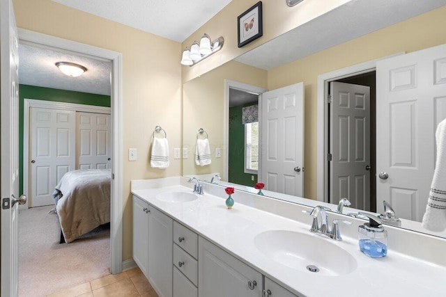 345 Quarter Way, Delaware, OH 43015 - ensuite bathroom featuring double vanity, tile patterned floors, and baseboards