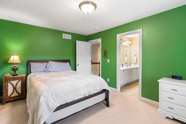 345 Quarter Way, Delaware, OH 43015 - bedroom with light colored carpet, baseboards, and connected bathroom