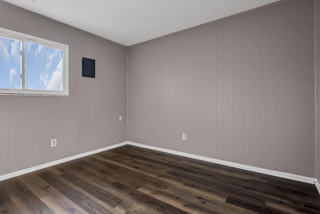 2872 Howey Rd, Columbus, OH 43224 - empty room with dark wood-style floors, baseboards, and a textured ceiling