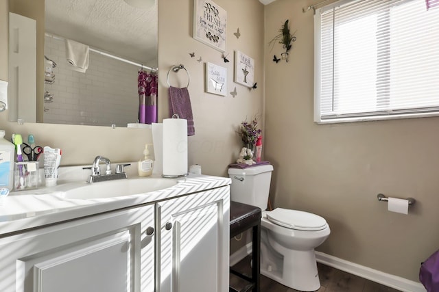 2872 Howey Rd, Columbus, OH 43224 - bathroom with toilet, vanity, a shower with shower curtain, wood finished floors, and baseboards