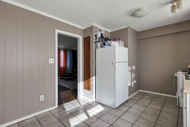 2872 Howey Rd, Columbus, OH 43224 - kitchen with white appliances, light tile patterned floors, ornamental molding, light countertops, and baseboards