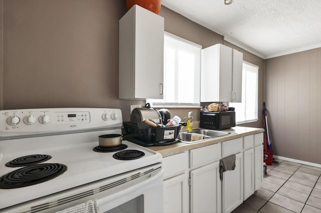 2872 Howey Rd, Columbus, OH 43224 - kitchen featuring range with electric stovetop, white cabinets, light countertops, a textured ceiling, and light tile patterned floors
