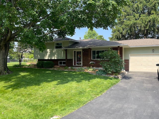 4580 Astral Dr, Hilliard, OH 43026 - split level home with brick siding, an attached garage, and asphalt driveway