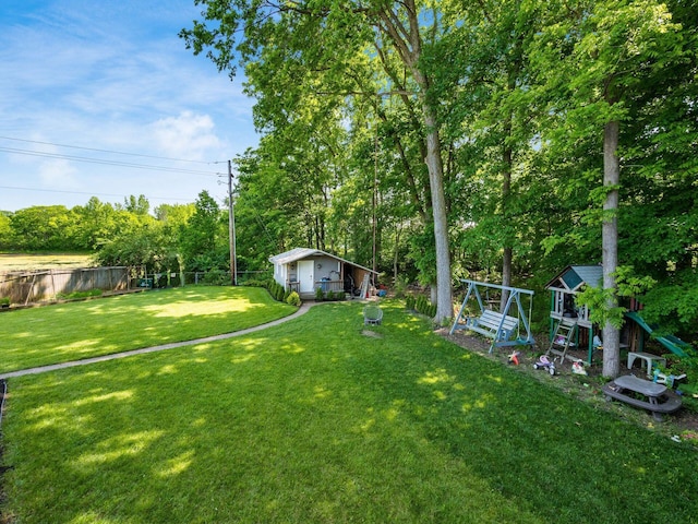 2073 Jeffey Dr, Hilliard, OH 43026 - view of yard with a playground, an outdoor structure, and view of wooded area