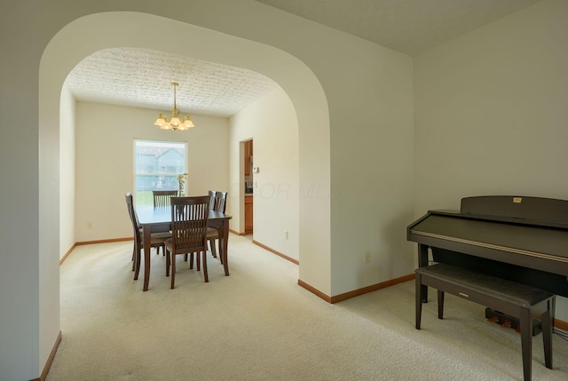 1300 Sotherby Xing, Lewis Center, OH 43035 - dining area with arched walkways, a chandelier, light colored carpet, and baseboards