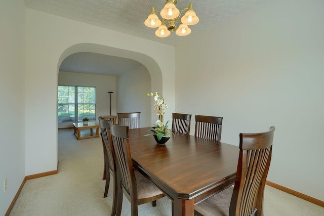 1300 Sotherby Xing, Lewis Center, OH 43035 - dining room with arched walkways, light carpet, a chandelier, and baseboards