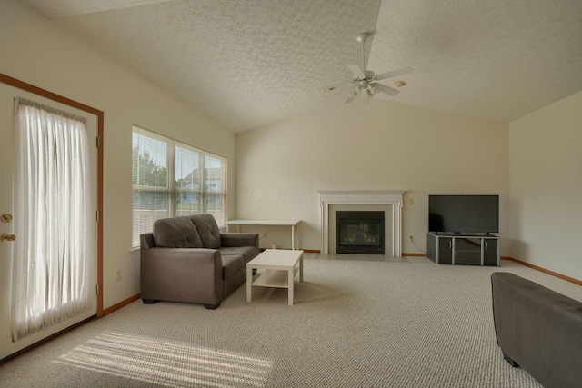 1300 Sotherby Xing, Lewis Center, OH 43035 - carpeted living room with a fireplace with flush hearth, ceiling fan, baseboards, lofted ceiling, and a textured ceiling