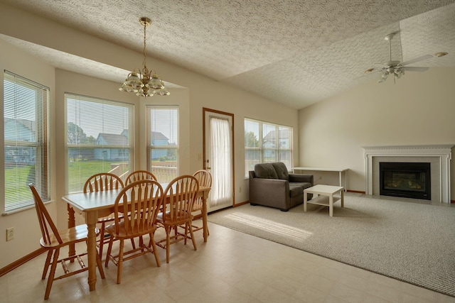 1300 Sotherby Xing, Lewis Center, OH 43035 - dining space with a textured ceiling, vaulted ceiling, a fireplace with flush hearth, a chandelier, and light flooring