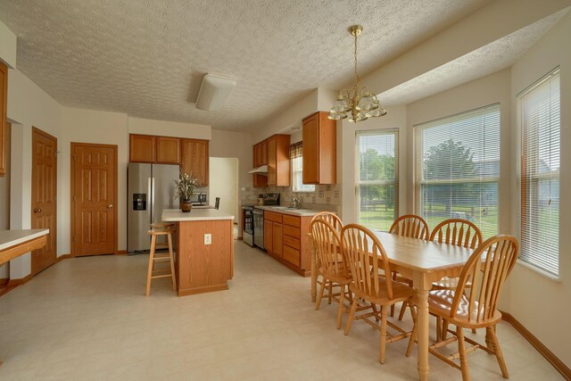 1300 Sotherby Xing, Lewis Center, OH 43035 - kitchen featuring appliances with stainless steel finishes, light countertops, a kitchen island, a sink, and light flooring