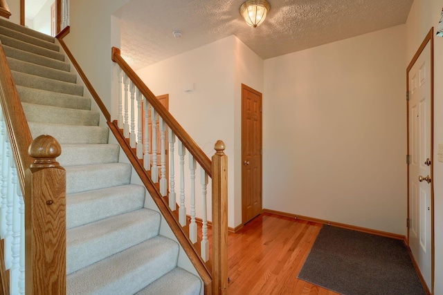 1300 Sotherby Xing, Lewis Center, OH 43035 - stairway with wood finished floors, a textured ceiling, and baseboards