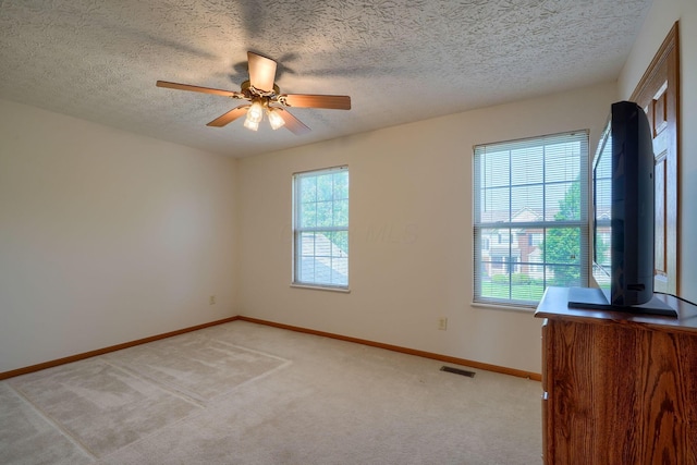 1300 Sotherby Xing, Lewis Center, OH 43035 - empty room with light colored carpet, ceiling fan, baseboards, and a textured ceiling