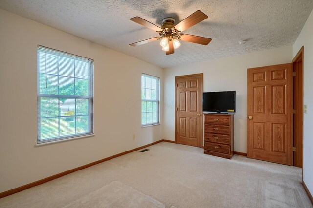 1300 Sotherby Xing, Lewis Center, OH 43035 - unfurnished bedroom with a textured ceiling, light colored carpet, baseboards, and ceiling fan