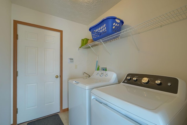 1300 Sotherby Xing, Lewis Center, OH 43035 - laundry room with washer and dryer, a textured ceiling, and light tile patterned flooring