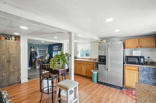1106 E Walnut St, Lancaster, OH 43130 - kitchen featuring stainless steel fridge with ice dispenser, black microwave, light wood finished floors, light countertops, and recessed lighting