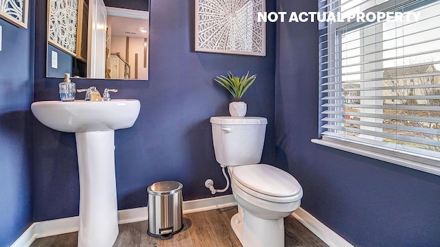 904 Allegro Dr, Reynoldsburg, OH 43068 - bathroom featuring healthy amount of natural light, wood finished floors, baseboards, and toilet