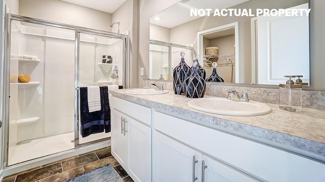 904 Allegro Dr, Reynoldsburg, OH 43068 - full bathroom featuring a shower stall, double vanity, a spacious closet, and stone finish floors