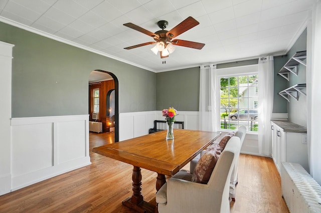 4 Greer St, Mount Vernon, OH 43050 - dining space featuring arched walkways, ceiling fan, ornamental molding, light wood-style floors, and a wainscoted wall