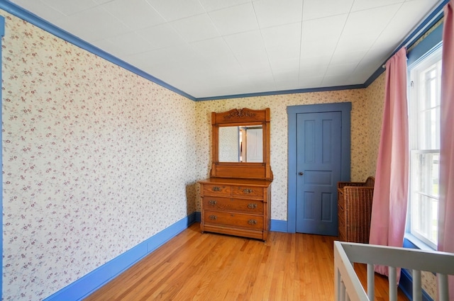 4 Greer St, Mount Vernon, OH 43050 - bedroom featuring crown molding, light wood-type flooring, wallpapered walls, and baseboards