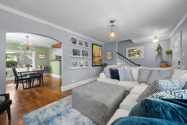 472 Tibet Rd, Columbus, OH 43202 - living room featuring a chandelier, arched walkways, crown molding, plenty of natural light, and wood finished floors