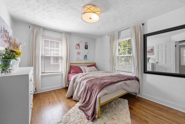 472 Tibet Rd, Columbus, OH 43202 - bedroom featuring baseboards, light wood-style flooring, and a textured ceiling