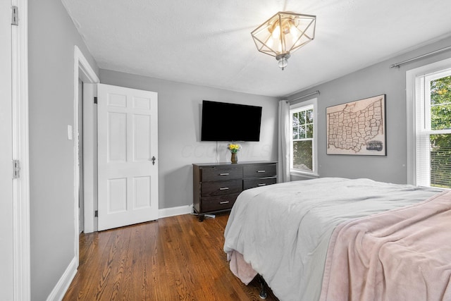 472 Tibet Rd, Columbus, OH 43202 - bedroom featuring baseboards and dark wood-style floors