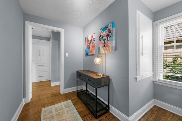 472 Tibet Rd, Columbus, OH 43202 - hallway with baseboards, dark wood-type flooring, and a textured ceiling
