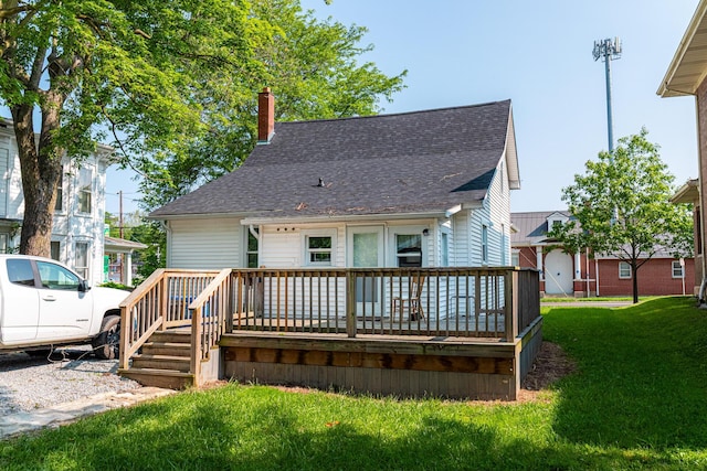 77 W High St, Mount Gilead, OH 43338 - back of property featuring a deck, a yard, a shingled roof, and a chimney