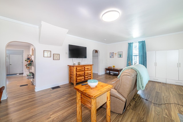 77 W High St, Mount Gilead, OH 43338 - living room with arched walkways, ornamental molding, wood finished floors, and baseboards