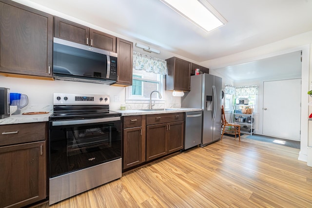 77 W High St, Mount Gilead, OH 43338 - kitchen featuring stainless steel appliances, a sink, light countertops, and light wood finished floors