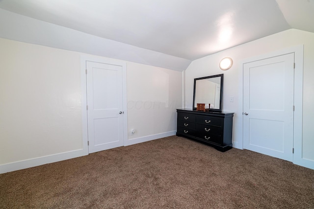 77 W High St, Mount Gilead, OH 43338 - unfurnished bedroom with lofted ceiling, dark carpet, and baseboards